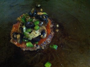 Top vegetables onto the patty.