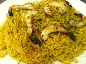 Toss in egg noodles and finish with fresh Parmesan, parsley and grilled prawns.
