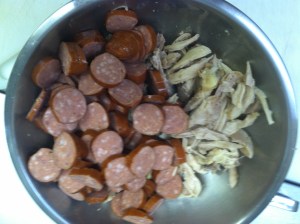 Remove chicken from bone and chop sausage.