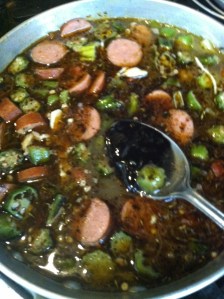 Add roux and season with Cajun seasoning, thyme, basil, bay leaf, salt and pepper.   