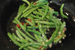 Add habaneros and green beans.  Continue to toss till green beans are cooked.