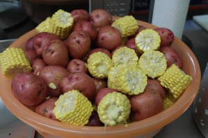 Prep corn and potatoes.