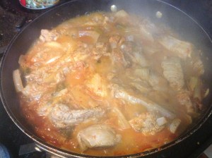 Add vegetable oil to a large pan, add kimchi and sliced pork ribs.  I used St Louis ribs since they're my favourite.  Add small amount of water to keep from burning and cook till pork reads 165F.  