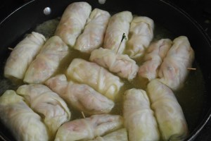 Bring reserve cabbage broth, chicken stock, chicken bouillon to simmer and add rolls.