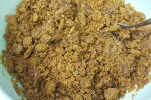 Crumble cooled crackers with melted butter and sugar.