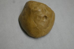 Remove dough on prepared waxed paper.