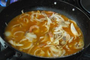 Add chicken broth and bring to a boil.