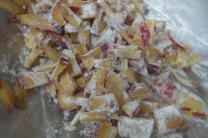 Pit, slice and dice plums. Toss with 1 Tbspn. Flour and set aside.
