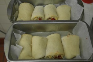 I sliced the rolls in half and filled two loaf pans.  Allow to rise for 45 minutes.  Egg wash and bake 25-30 minutes.