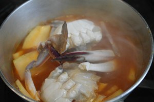 When daikon is about half cooked, add crab.