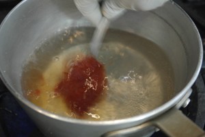 Add chili paste to boiling water.