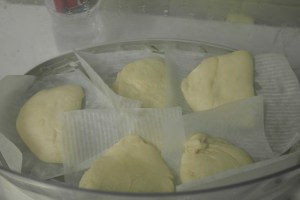 Carefully place into steamer.  Be sure not to the paper from other buns.  Do not over crowd.  (My parchment were too big.)