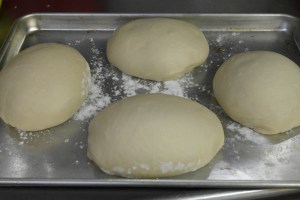 Divide into quarters and place on a sheet pan to proof again. Wrap and keep in warm area.