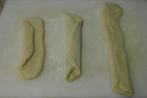 Roll out into ovals and fold like a letter. Roll out again to make strips.