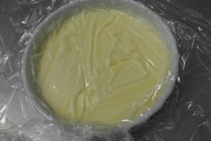 Using cling wrap, remove bubbles/foam.