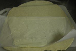 After rolling out divided dough, add butter block.  Fold like an envelope.  Roll out again and repeat.