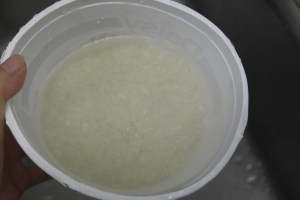 Rinse and rub rice again.  Rinse water till it runs clear.