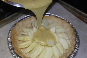 Slowly pour filling over apples.