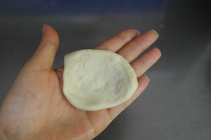 Flatten with hands into a disk.