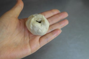 Should have a small little gap on top where thumb was pressing.  (Little air gap helps release heat for uncooked ingredients.)