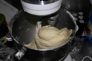 Change to dough hook.  Add flour till dough pulls away from bowl.